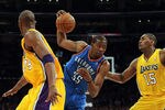LOS ANGELES, CA - MARCH 29:  Kevin Durant #35 of the Oklahoma City Thunder cuts between Metta World Peace #15 and Kobe Bryant #24 of the Los Angeles Lakers at Staples Center on March 29, 2012 in Los Angeles, California.  NOTE TO USER: User expressly acknowledges and agrees that, by downloading and or using this photograph, User is consenting to the terms and conditions of the Getty Images License Agreement.  (Photo by Harry How/Getty Images)