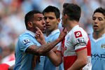 MANCHESTER, ENGLAND - MAY 13:  Carlos Tevez of Manchester City clashes with Joey Barton of QPR after being fouled during the Barclays Premier League match between Manchester City and Queens Park Rangers at the Etihad Stadium on May 13, 2012 in Manchester, England.  (Photo by Alex Livesey/Getty Images)