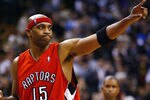 TORONTO - NOVEMBER 3:   Vince Carter #15 of the Toronto Raptors salutes the crowd after beating the Houston Rockets 95-88 during a game at the Air Canada Centre on November 3, 2003 in Toronto, Canada.  NOTE TO USER: User expressly acknowledges and agrees that, by downloading and or using this photograph, User is consenting to the terms and conditions of the Getty Images License Agreement. (Photo by Dave Sandford/Getty Images)