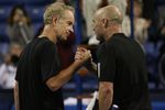 LOS ANGELES, CA - JULY 24:  John McEnroe, left congratulates Andre Agassi after the Stars Under the Stars gala on July 24, 2010 at the Los Angeles Tennis Center in Los Angeles, California.  Andre Agassi defeated John McEnroe 6-4, 6-2.  (Photo by Jeff Golden/Getty Images)