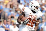 PASADENA, CA - SEPTEMBER 17:  Malcolm Brown #28 of the Texas Longhorns takes a handoff against the UCLA Bruins at Rose Bowl on September 17, 2011 in Pasadena, California.  (Photo by Harry How/Getty Images)