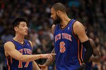 DALLAS, TX - MARCH 06:  Jeremy Lin #17 of the New York Knicks talks with Tyson Chandler during play against the Dallas Mavericks at American Airlines Center on March 6, 2012 in Dallas, Texas.  NOTE TO USER: User expressly acknowledges and agrees that, by downloading and or using this photograph, User is consenting to the terms and conditions of the Getty Images License Agreement.  (Photo by Ronald Martinez/Getty Images)
