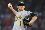 BOSTON, MA - MAY 1:  Jarrod Parker #11 of the Oakland Athletics throws against the Oakland Athletics at Fenway Park May 1, 2012  in Boston, Massachusetts. (Photo by Jim Rogash/Getty Images)
