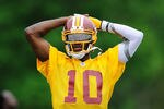 ASHBURN, VA - MAY 06:  Robert Griffin III #10 of the Washington Redskins practices during the Washington Redskins rookie minicamp on May 6, 2012 in Ashburn, Virginia.  (Photo by Patrick McDermott/Getty Images)