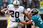 JACKSONVILLE, FL - DECEMBER 12:  Darren McFadden #20 of the Oakland Raiders breaks the tackle of Sean Considine #37 of the Jacksonville Jaguars during the game at EverBank Field on December 12, 2010 in Jacksonville, Florida.  (Photo by Sam Greenwood/Getty Images)