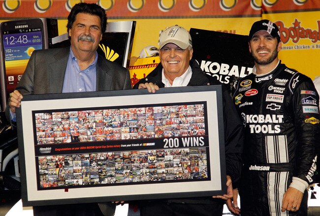 DARLINGTON, SC - MAY 12:  (R-L) Jimmie Johnson, driver of the #48 Lowe's/Kobalt Tools Chevrolet, celebrates in Victory Lane with team owner Rick Hendrick and NASCAR President Mike Helton after winning the NASCAR Sprint Cup Series Bojangles' Southern 500 at Darlington Raceway on May 12, 2012 in Darlington, South Carolina. This is the 200th win for Hendrick Motorsports.  (Photo by Todd Warshaw/Getty Images)