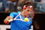 ROME, ITALY - MAY 16:  Roger Federer of Switzerland plays a backhand against Carlos Berlocq of Argentina in their second round match during day five of the Internazionali BNL d'Italia 2012 at the Foro Italico Tennis Centre on May 16, 2012 in Rome, Italy.  (Photo by Clive Brunskill/Getty Images)