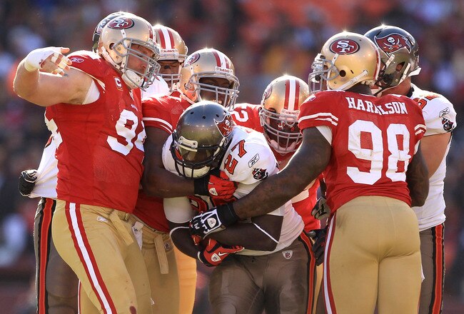 SAN FRANCISCO - NOVEMBER 21:  LeGarrette Blount #27 of the Tampa Bay Buccaneers is tackled by the San Francisco 49ers at Candlestick Park on November 21, 2010 in San Francisco, California.  (Photo by Ezra Shaw/Getty Images)