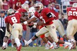 TALLAHASSEE, FL - NOVEMBER 12:  EJ Manuel #3 of the Florida State Seminoles hands off to Devonta Freeman #8 during a game against against the Miami Hurricanes at Doak Campbell Stadium on November 12, 2011 in Tallahassee, Florida.  (Photo by Mike Ehrmann/Getty Images)