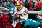 JACKSONVILLE, FL - DECEMBER 26:  Chris Cooley #47 of the Washington Redskins is tackled by Don Carey #22 of the Jacksonville Jaguars  during the game at EverBank Field on December 26, 2010 in Jacksonville, Florida.  (Photo by Sam Greenwood/Getty Images)