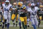GREEN BAY, WI - JANUARY 01:  Donald Driver #80 of the Green Bay Packers breaks away from Chris Harris #43 and Lawrence Jackson #94 of the Detroit Lions to score a touchdown at Lambeau Field on January 1, 2012 in Green Bay, Wisconsin. The Packers defeated the Lions 45-41.  (Photo by Jonathan Daniel/Getty Images)