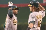 ANAHEIM, CA - APRIL 18:  Yoenis Cespedes #52 of the Oakland Athletics celebrates with Josh Reddick #16 after both score on Cespedes' three run home run in the first inning against the Los Angeles Angels of Anaheim at Angel Stadium of Anaheim on April 18, 2012 in Anaheim, California.  (Photo by Stephen Dunn/Getty Images)