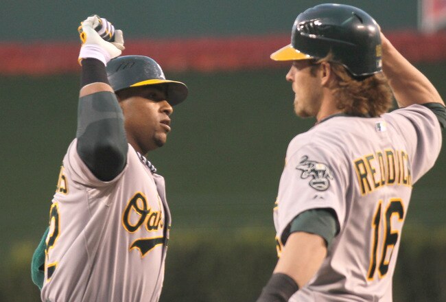 ANAHEIM, CA - APRIL 18:  Yoenis Cespedes #52 of the Oakland Athletics celebrates with Josh Reddick #16 after both score on Cespedes' three run home run in the first inning against the Los Angeles Angels of Anaheim at Angel Stadium of Anaheim on April 18, 2012 in Anaheim, California.  (Photo by Stephen Dunn/Getty Images)