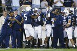 ORCHARD PARK, NY - SEPTEMBER 14:  Larry Johnson #5 of Penn State celebrates scoring Penn State's first touchdown against Nebraska with teammates Ricky Upton #44 and Bryant Johnson #24 during their NCAA football game on September 14, 2002 at Beaver Stadium in State College, Pennsylvania.  Penn State defeated Nebraska 40-7.  (Photo by Rick Stewart/Getty Images)