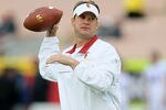 LOS ANGELES, CA - NOVEMBER 12: Head coach Lane Kiffin of the USC Trojans tosses a football before the game with the Washington Huskies at the Los Angeles Memorial Coliseum on November 12, 2011 in Los Angeles, California.  USC won 40-17.  (Photo by Stephen Dunn/Getty Images)