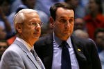 CHAPEL HILL, NC - MARCH 04:  Head coach Mike Krzyzewski (R) of the Duke Blue Devils waits on the officials with head coach Roy Williams of the University of North Carolina Tar Heels after an incident involving Tyler Hansbrough and Gerald Henderson during their game at the Dean E. Smith Center on March 4, 2007 in Chapel Hill, North Carolina. North Carolina defeated Duke, 86 - 72.  (Photo by Streeter Lecka/Getty Images)