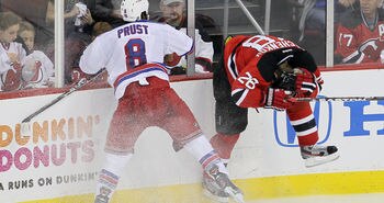NEWARK, NJ - MAY 19:  Brandon Prust #8 of the New York Rangers checks Anton Volchenkov #28 of the New Jersey Devils in Game Three of the Eastern Conference Final during the 2012 NHL Stanley Cup Playoffs at the Prudential Center on May 19, 2012 in Newark, New Jersey.  (Photo by Jim McIsaac/Getty Images)