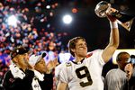 MIAMI GARDENS, FL - FEBRUARY 07:  Quarterback Drew Brees #9 of the New Orleans Saints celebrates with the Vince Lombardi Trophy after his team defeated the Indianapolis Colts during Super Bowl XLIV on February 7, 2010 at Sun Life Stadium in Miami Gardens, Florida.  (Photo by Chris Graythen/Getty Images)