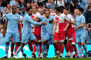 MANCHESTER, ENGLAND - MAY 13:  Joey Barton of QPR causes a fracas after being shown the red card by Referee Mike Dean during the Barclays Premier League match between Manchester City and Queens Park Rangers at the Etihad Stadium on May 13, 2012 in Manchester, England.  (Photo by Shaun Botterill/Getty Images)