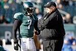 PHILADELPHIA, PA - JANUARY 01:  Michael Vick #7 of the Philadelphia Eagles talks with head coach Andy Reid before the start of the Eagles game against the Washington Redskins at Lincoln Financial Field on January 1, 2012 in Philadelphia, Pennsylvania.  (Photo by Rob Carr/Getty Images)