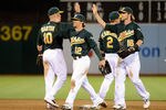 OAKLAND, CA - MAY 21:  Collin Cowgill #12, Daric Barton #10, Cliff Pennington #2 and Josh Reddick #16 of the Oakland Athletics celebrate defeating the Los Angeles Angels of Anaheim 2 to 1 at O.co Coliseum on May 21, 2012 in Oakland, California.  (Photo by Thearon W. Henderson/Getty Images)