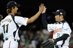 LOS ANGELES, CA - MARCH 22:  Pitcher Yu Darvish #11 and Ichiro Suzuki #51 of Japan celebrate after defeating the United States to win the semifinal game of the 2009 World Baseball Classic on March 22, 2009 at Dodger Stadium in Los Angeles, California. Japan defeated the United States 9-4.  (Photo by Kevork Djansezian/Getty Images)