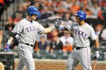 BALTIMORE, MD - MAY 8:  Josh Hamilton #10 of the Texas Rangers celebrates with Adrian Beltre #29 hitting a two-run home run in the third inning during a baseball game against the Baltimore Orioles at Oriole Park at Camden Yards on May 8, 2012 in Baltimore, Maryland.  (Photo by Mitchell Layton/Getty Images)