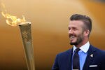 HELSTON, ENGLAND - MAY 18:  David Beckham holds the Olympic Flame as it arrives at RNAS Culdrose near Helston on May 18, 2012 in Cornwall, England. The Olympic Flame arrived in the UK after it was handed over at a ceremony yesterday in Athens. A British delegation including David Beckham, flew back with the flame from Greece where they attended a ceremony welcoming the flame, before it is taken on a 70-day relay involving 8,000 torchbearers covering 8,000 miles.  (Photo by Matt Cardy/Getty Images)