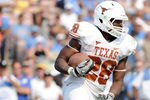 PASADENA, CA - SEPTEMBER 17:  Malcolm Brown #28 of the Texas Longhorns takes a handoff against the UCLA Bruins at Rose Bowl on September 17, 2011 in Pasadena, California.  (Photo by Harry How/Getty Images)