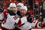 PHILADELPHIA, PA - MAY 08: Ilya Kovalchuk #17 of the New Jersey Devils celebrates his powerplay goal at 5:00 of the third period against the Philadelphia Flyers in Game Five of the Eastern Conference Semifinals during the 2012 NHL Stanley Cup Playoffs at Wells Fargo Center on May 8, 2012 in Philadelphia, Pennsylvania.  Joining him are Travis Zajac #19 (L) and Adam Larsson #5 (C). (Photo by Bruce Bennett/Getty Images)