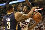 MIAMI, FL - MAY 13: Forward Udonis Haslem #40 of the Miami Heat is defended by Guard George Hill #3 and Center Roy Hibbert #55 of the Indiana Pacers in Game One of the Eastern Conference Semifinals in the 2012 NBA Playoffs on May 13, 2012 at the American Airines Arena in Miami, Florida. NOTE TO USER: User expressly acknowledges and agrees that, by downloading and or using this photograph, User is consenting to the terms and conditions of the Getty Images License Agreement.  (Photo by Marc Serota/Getty Images)