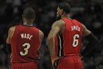 CHICAGO, IL - APRIL 12:  Dwyane Wade #3 and LeBron James #6 of the Miami Heat wait as a member of the Chicago Bulls shoots a free-throw at the United Center on April 12, 2012 in Chicago, Illinois. The Bulls defeated the Heat 96-86 in overtime. NOTE TO USER: User expressly acknowledges and agrees that, by downloading and or using this photograph, User is consenting to the terms and conditions of the Getty Images License Agreement.  (Photo by Jonathan Daniel/Getty Images)