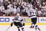GLENDALE, AZ - MAY 22:  Jeff Carter #77 and Mike Richards #10 react after Dustin Penner scores the game-winning goal in overtime as the Kings defeat the Phoenix Coyotes 4-3 in Game Five of the Western Conference Final during the 2012 NHL Stanley Cup Playoffs at Jobing.com Arena on May 22, 2012 in Phoenix, Arizona.  (Photo by Jeff Gross/Getty Images)