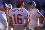 TEMPE, AZ - NOVEMBER 6:  Quarterbacks Steve Young #8 and Joe Montana #16 of the San Francisco 49ers discuss strategy with head coach Bill Walsh during the game against the Phoenix Cardinals at Sun Devil Stadium on Novemer 6, 1988 in Tempe, Arizona.  The Cardinals won 24-23.  (Photo by George Rose/Getty Images)