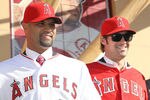 ANAHEIM, CA - DECEMBER 10:  Albert Pujols #5 (L) and C.J. Wilson #33 stand together at a public press conference introducing them as newly signed Los Angeles Angels of Anaheim  players at Angel Stadium on December 10, 2011 in Anaheim, California.  (Photo by Stephen Dunn/Getty Images)
