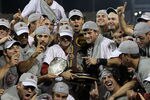 OMAHA, NE - JUNE 28:  (L-R) Brady Thomas #36 and Scott Wingo #8 of the South Carolina Gamecocks celebrate with the team while holding the trophy after winning the men's 2011 NCAA College Baseball World Series at TD Ameritrade Park Omaha on June 28, 2011 in Omaha, Nebraska.  The Gamecocks defeated the Florida Gators 5-2 and won the series 2-0.  (Photo by Ronald Martinez/Getty Images)
