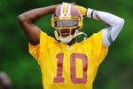 ASHBURN, VA - MAY 06:  Robert Griffin III #10 of the Washington Redskins practices during the Washington Redskins rookie minicamp on May 6, 2012 in Ashburn, Virginia.  (Photo by Patrick McDermott/Getty Images)