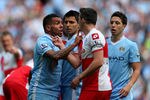 MANCHESTER, ENGLAND - MAY 13:  Carlos Tevez of Manchester City clashes with Joey Barton of QPR after being fouled during the Barclays Premier League match between Manchester City and Queens Park Rangers at the Etihad Stadium on May 13, 2012 in Manchester, England.  (Photo by Alex Livesey/Getty Images)