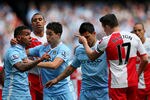 MANCHESTER, ENGLAND - MAY 13:  Carlos Tevez of Manchester City clashes with Joey Barton of QPR after being fouled during the Barclays Premier League match between Manchester City and Queens Park Rangers at the Etihad Stadium on May 13, 2012 in Manchester, England.  (Photo by Alex Livesey/Getty Images)