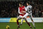SWANSEA, WALES - JANUARY 15:  Aaron Ramsey of Arsenal is closed down by Joe Allen of Swansea City during the Barclays Premier League match between Swansea City and Arsenal at Liberty Stadium on January 15, 2012 in Swansea, Wales.  (Photo by Michael Steele/Getty Images)