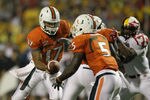 COLLEGE PARK, MD - SEPTEMBER 05: Quarterback Stephen Morris #17 of the Miami Hurricanes hands the ball off to running back Mike James #5 during the first half against the Maryland Terrapins at Byrd Stadium on September 5, 2011 in College Park, Maryland.  (Photo by Rob Carr/Getty Images)