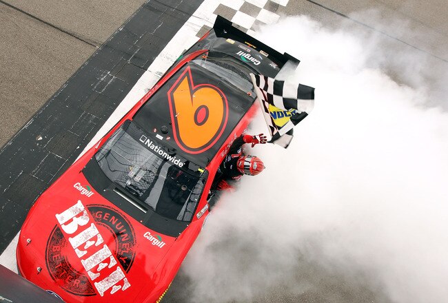 NEWTON, IA - MAY 20:  Ricky Stenhouse, Jr., driver of the #6 Cargill Ford, catches the checkered flag dropped by the flagman after winning the NASCAR Nationwide Series Pioneer Hi-Bred 250 at Iowa Speedway on May 20, 2012 in Newton, Iowa.  (Photo by Jamie Squire/Getty Images for NASCAR)