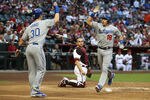 PHOENIX, AZ - MAY 21:  Matt Treanor #18 (R) of the Los Angeles Dodgers high fives Jerry Sands #30 after hitting a two run home-run against the Arizona Diamondbacks during the second inning of the MLB game at Chase Field on May 21, 2012 in Phoenix, Arizona.  (Photo by Christian Petersen/Getty Images)