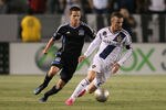 CARSON, CA - MAY 23:  David Beckham #23 of the Los Angeles Galaxy turns on the ball as Sam Cronin #4 of the San Jose Earthquakes pursues the play in the first half of the MLS match at The Home Depot Center on May 23, 2012 in Carson, California.  (Photo by Victor Decolongon/Getty Images)