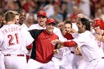 CINCINNATI, OH - MAY 23:  Todd Frazier #21 of the Cincinnati Reds appraoches his celebrating teammates after hitting a game winning home run in the 9th inning during the game against the Atlanta Braves at Great American Ball Park on May 23, 2012 in Cincinnati, Ohio. The Reds won 2-1.  (Photo by Andy Lyons/Getty Images)