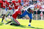 JACKSONVILLE, FL - OCTOBER 30:  Chris Rainey #3 of the Florida Gators attempts to break the tackle of Sanders Commings #19 of the Georgia Bulldogs during the game at EverBank Field on October 30, 2010 in Jacksonville, Florida.  (Photo by Sam Greenwood/Getty Images)