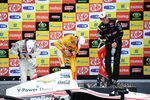 SAO PAULO, BRAZIL - APRIL 29:  (Left to right) Takuma Sato of Japan driver of the #Letterman Laningan Racing Dallara Honda,  Ryan Hunter-Reay driver of the #28 Andretti Autosport Dallara Chevrolet and Will Power of Australia driver of the #12 Team Penske Dallara Chevrolet try to open the champagne bottles after finishing respectively third, second and first during the IndyCar Series Sao Paulo indy 300 on April 29, 2012 in the streets of Sao Paulo in Sao Paulo, Brazil.  (Photo by Robert Laberge/Getty Images)
