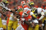 CHAMPAIGN, IL - NOVEMBER 12: Jason Ford #21 of the Illinois Fighting Illini grabs Troy Woolfolk #29 of the Michigan Wolverines as he is tackled by (L-R) Desmond Morgan #44, Ryan Van Bergen #53 and Craig Roh #88 at Memorial Stadium on November 12, 2011 in Champaign, Illinois. (Photo by Jonathan Daniel/Getty Images)