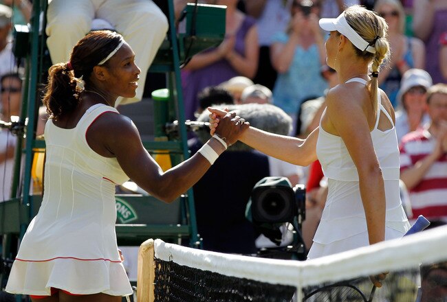 LONDON, ENGLAND - JUNE 28:  Serena Williams of USA (L) celebrates match point after her match against Maria Sharapova of Russia (R) on Day Seven of the Wimbledon Lawn Tennis Championships at the All England Lawn Tennis and Croquet Club on June 28, 2010 in London, England.  (Photo by Matthew Stockman/Getty Images)