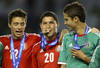 KANSAS CITY, KS - APRIL 2:  Hugo Gonzalez #20 of Mexico bites down on his metal as teammates Jose Rodriguez #12 and Diego Reyes #13 look on in the 2012 CONCACAF Men's Olympic Qualifying Finals against Honduras at Livestrong Sporting Park on April 2, 2012 in Kansas City, Kansas. (Photo by Ed Zurga/Getty Images)
